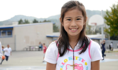 girl smiling on blacktop