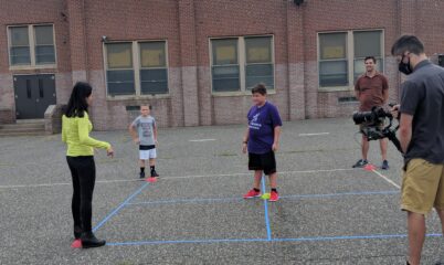 Child leading game on foursquare court